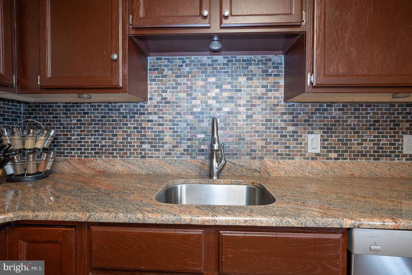 108 Valley Stream Circle, Unit 108A Chesterbrook, PA 19087 - Photo 10 of 22 a kitchen with granite countertop a sink and a wooden cabinets
