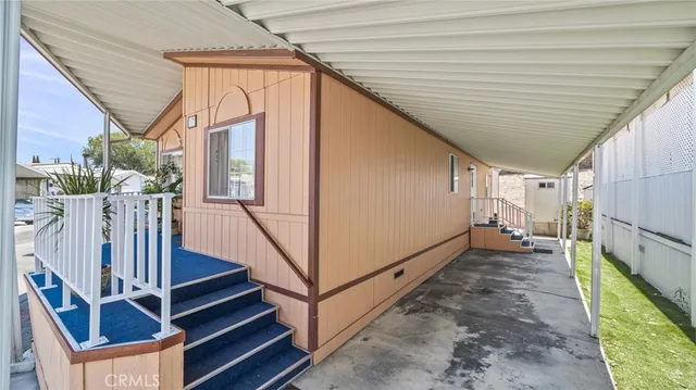 a view of a house with wooden walls and stairs