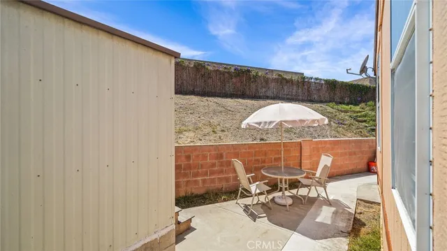 a view of a balcony with table and chairs