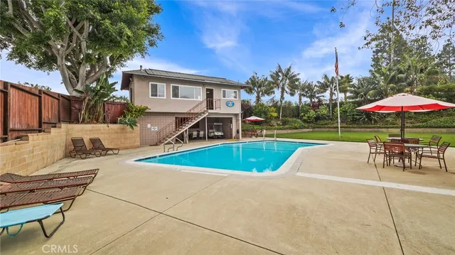 a view of a house with a yard and sitting area
