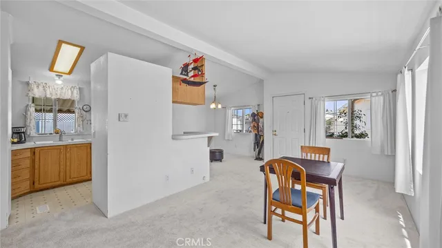 a living room with furniture and a kitchen