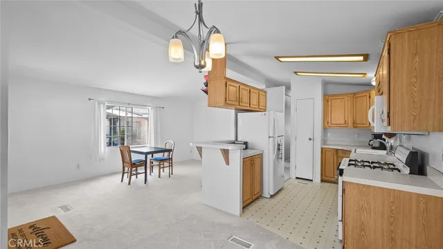 a view of kitchen with furniture and chandelier