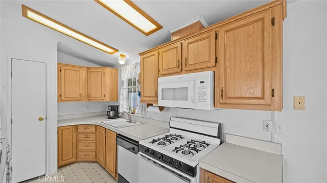 a kitchen with a stove a sink and a refrigerator