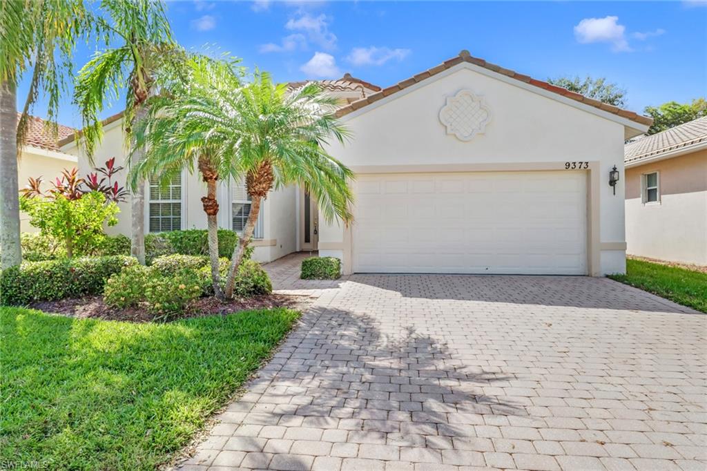 9373 Springview Loop Estero, FL 33928 - Photo 2 of 35 a front view of a house with a yard and garage