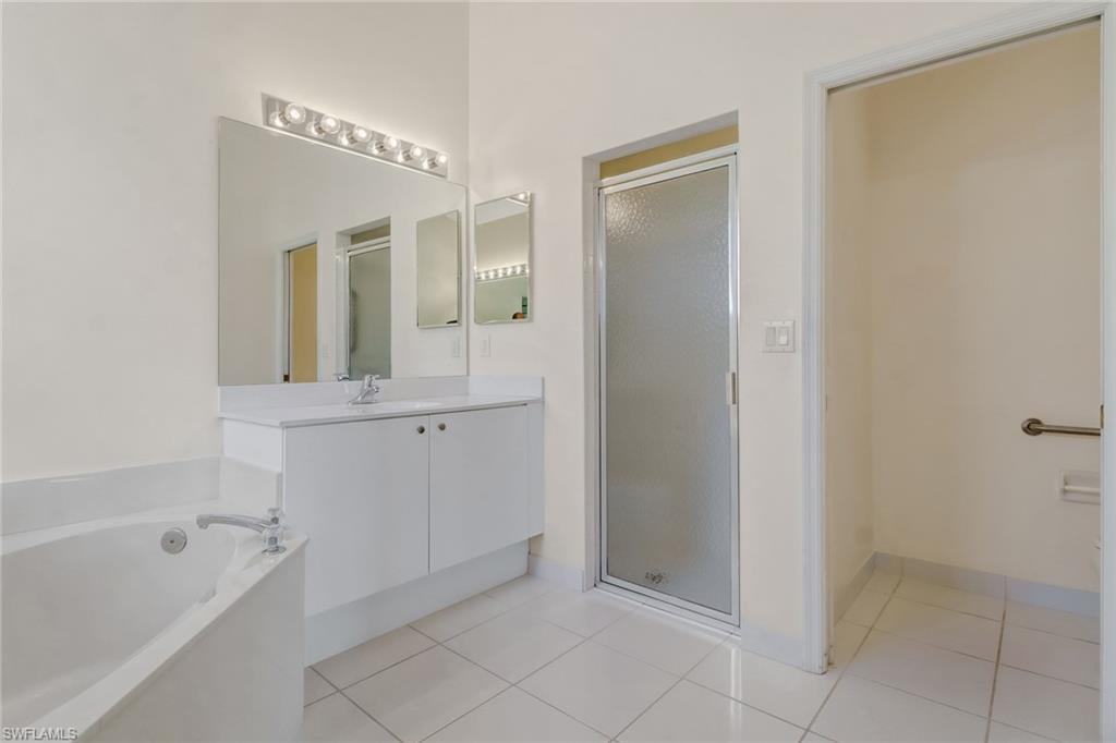 9373 Springview Loop Estero, FL 33928 - Photo 23 of 35 a bathroom with a bathtub and a shower
