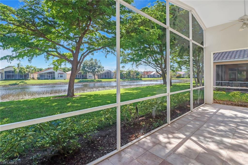 9373 Springview Loop Estero, FL 33928 - Photo 28 of 35 a view of a yard with potted plants and a large tree