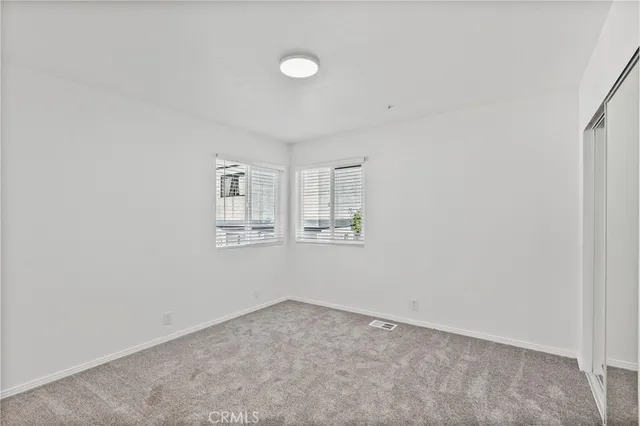 a living room with a large window and wooden floor