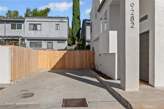 a view of a house with a wooden fence
