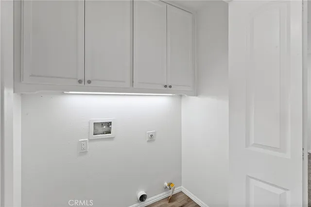 a view of a house with a floor to ceiling window and potted plants