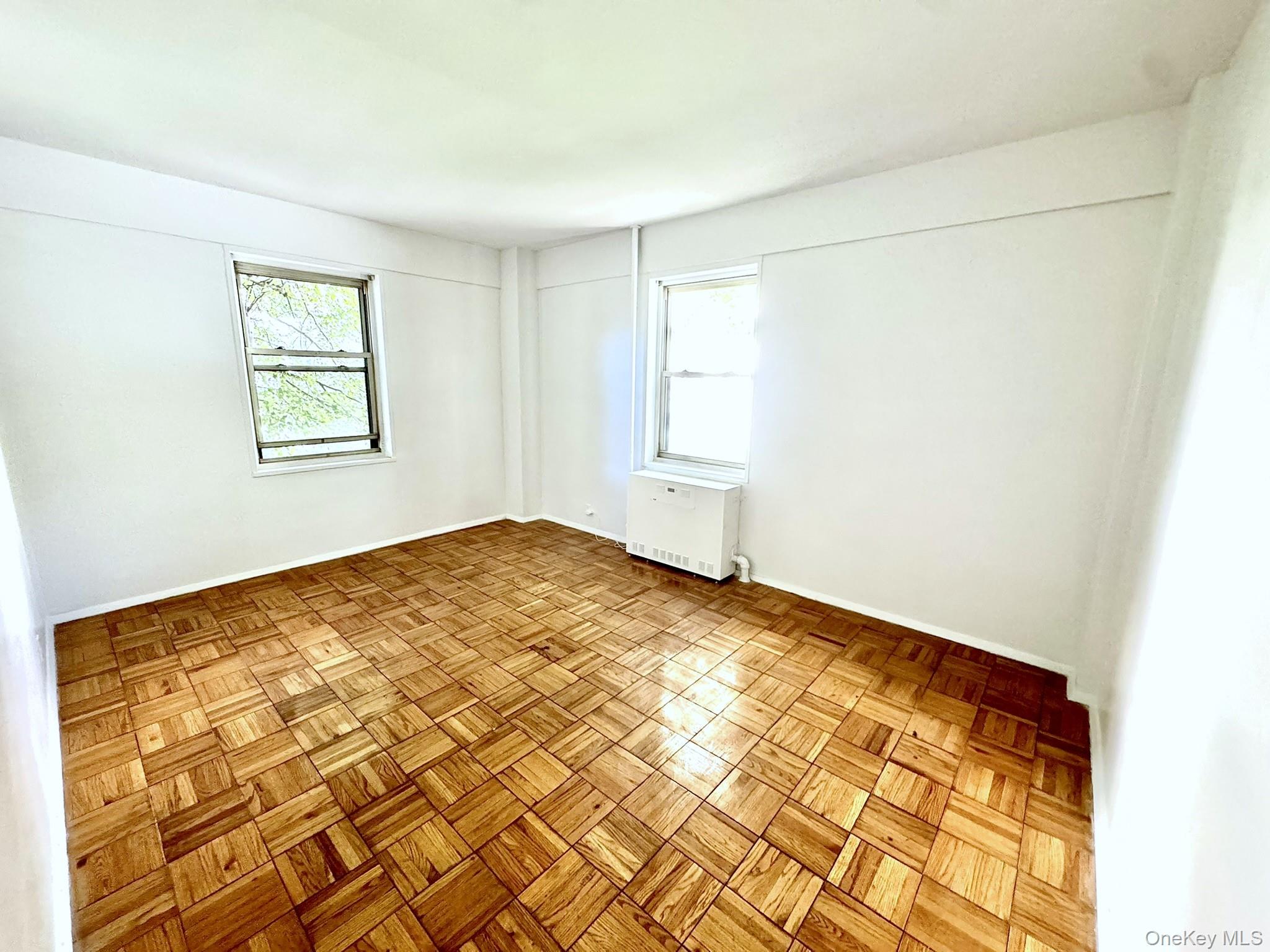 9 Fordham Hill Ovl, Unit 1H Bronx, NY 10468 - Photo 13 of 21 a view of empty room with wooden floor