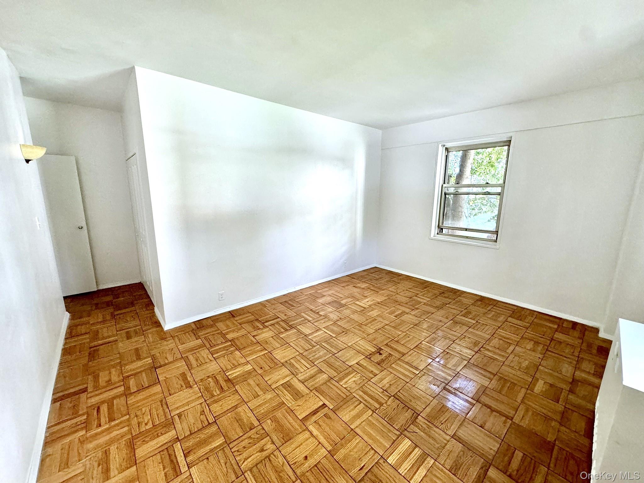 9 Fordham Hill Ovl, Unit 1H Bronx, NY 10468 - Photo 14 of 21 a view of empty room with wooden floor