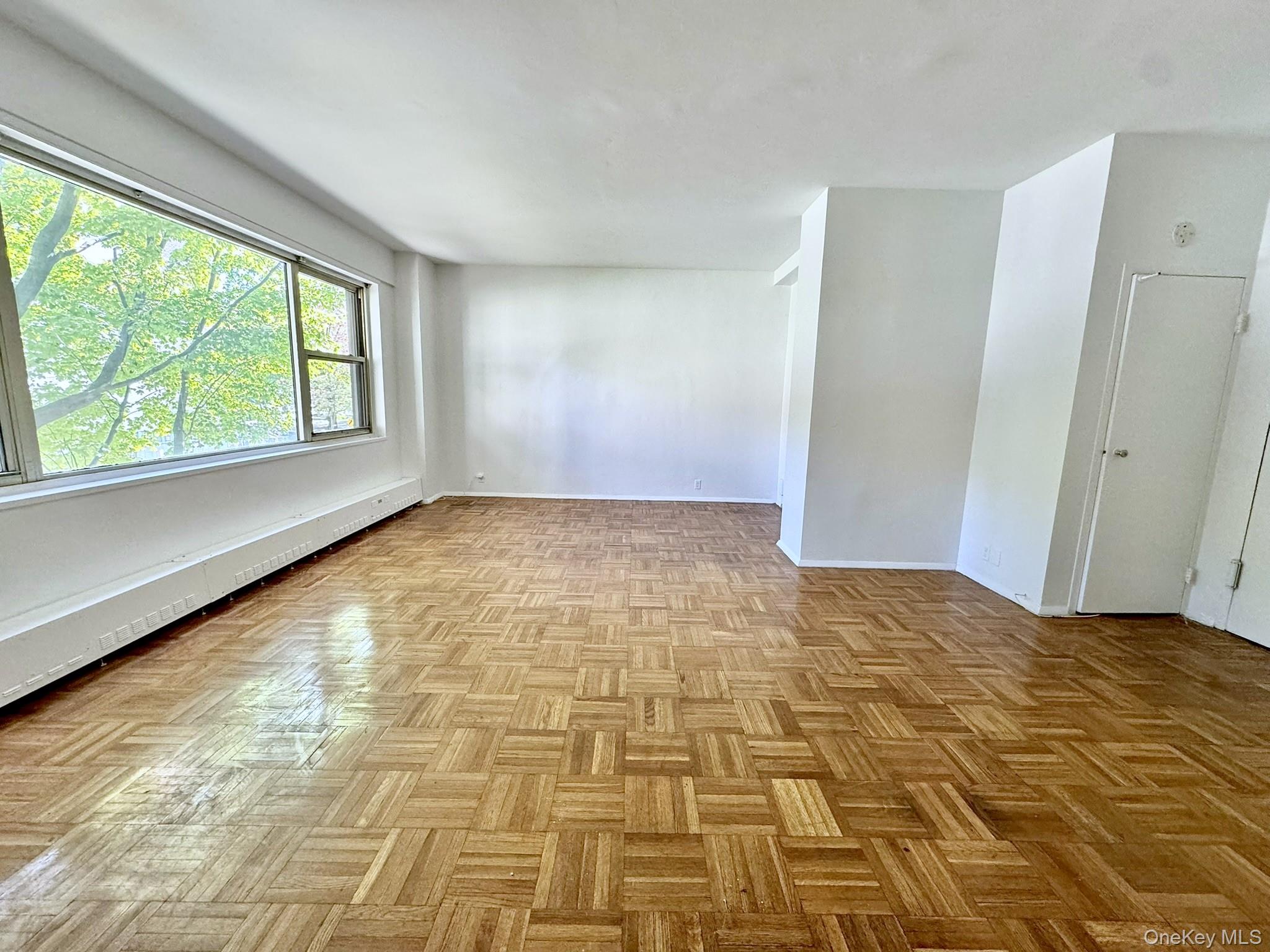9 Fordham Hill Ovl, Unit 1H Bronx, NY 10468 - Photo 16 of 21 a view of an empty room and window
