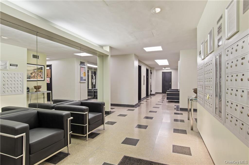 9 Fordham Hill Ovl, Unit 1H Bronx, NY 10468 - Photo 17 of 21 a living room with furniture and a table
