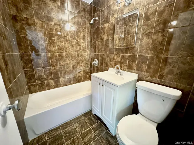 a bathroom with a toilet a sink and bathtub