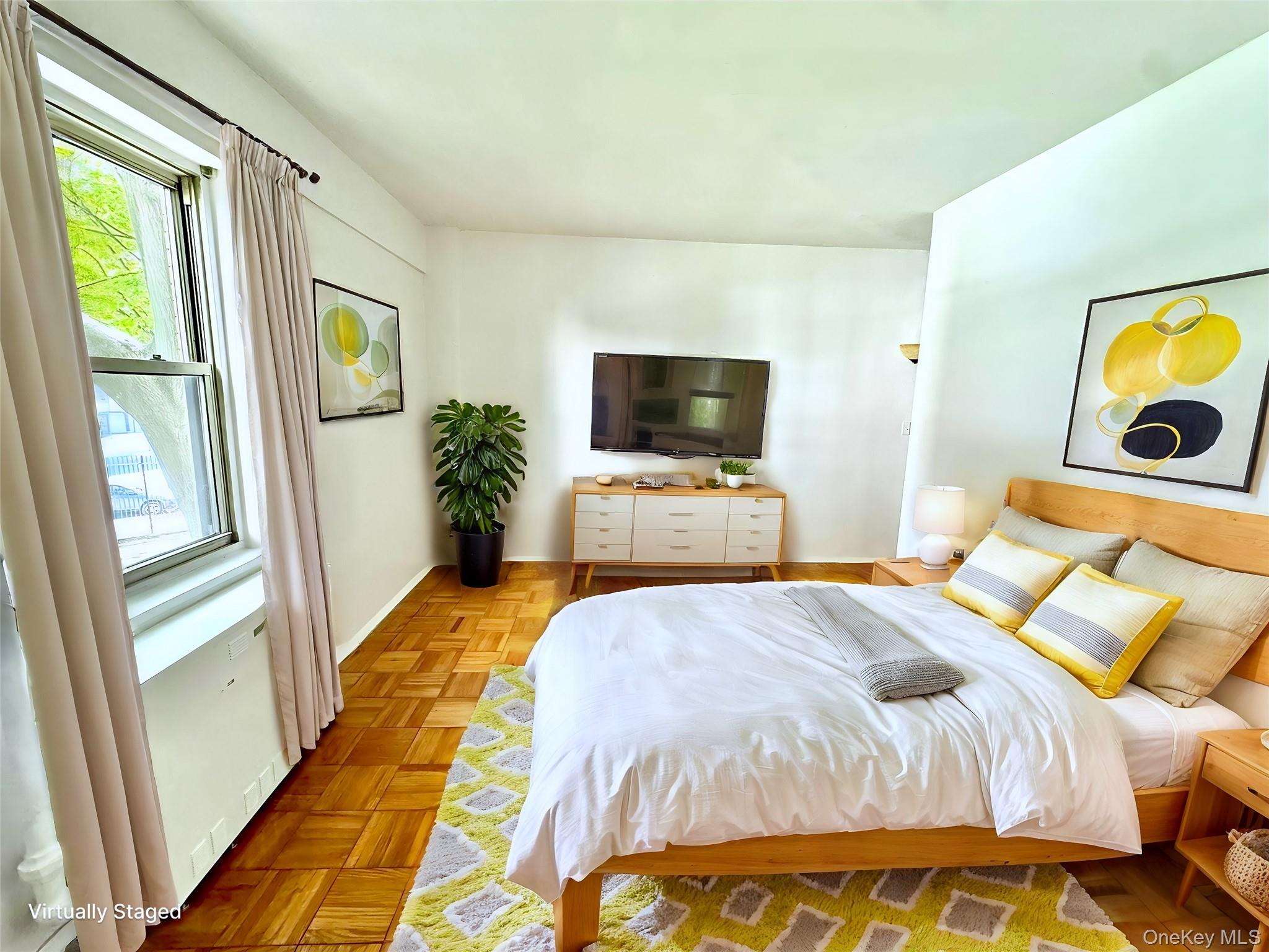 9 Fordham Hill Ovl, Unit 1H Bronx, NY 10468 - Photo 8 of 21 a bedroom with a bed and a flat screen tv