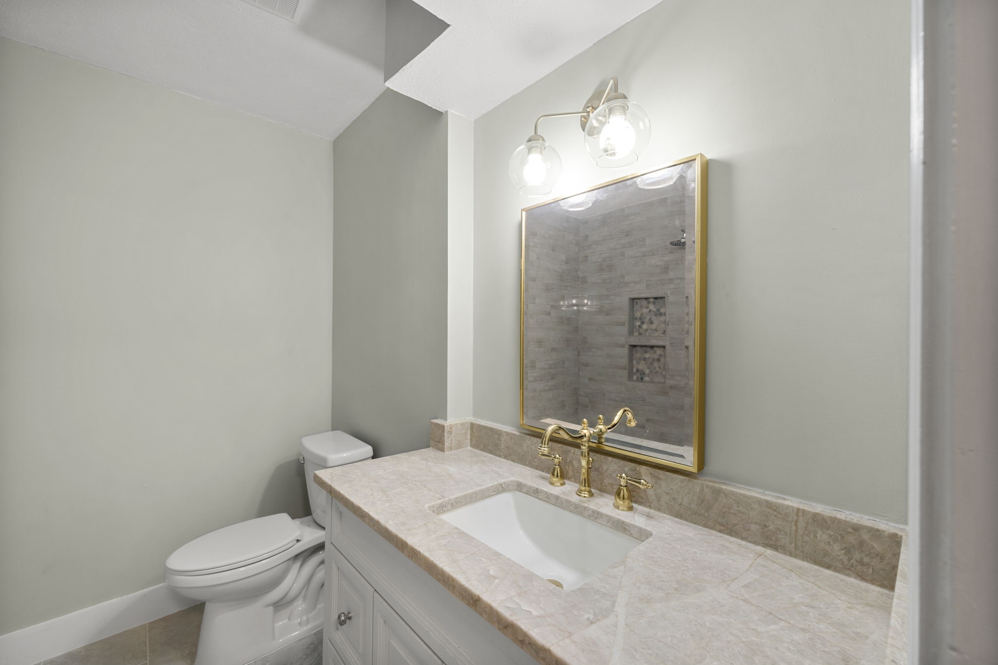 11550 Chimney Rock Road, Unit 521 Houston, TX 77035 - Photo 17 of 30 a bathroom with a granite countertop toilet a sink and mirror