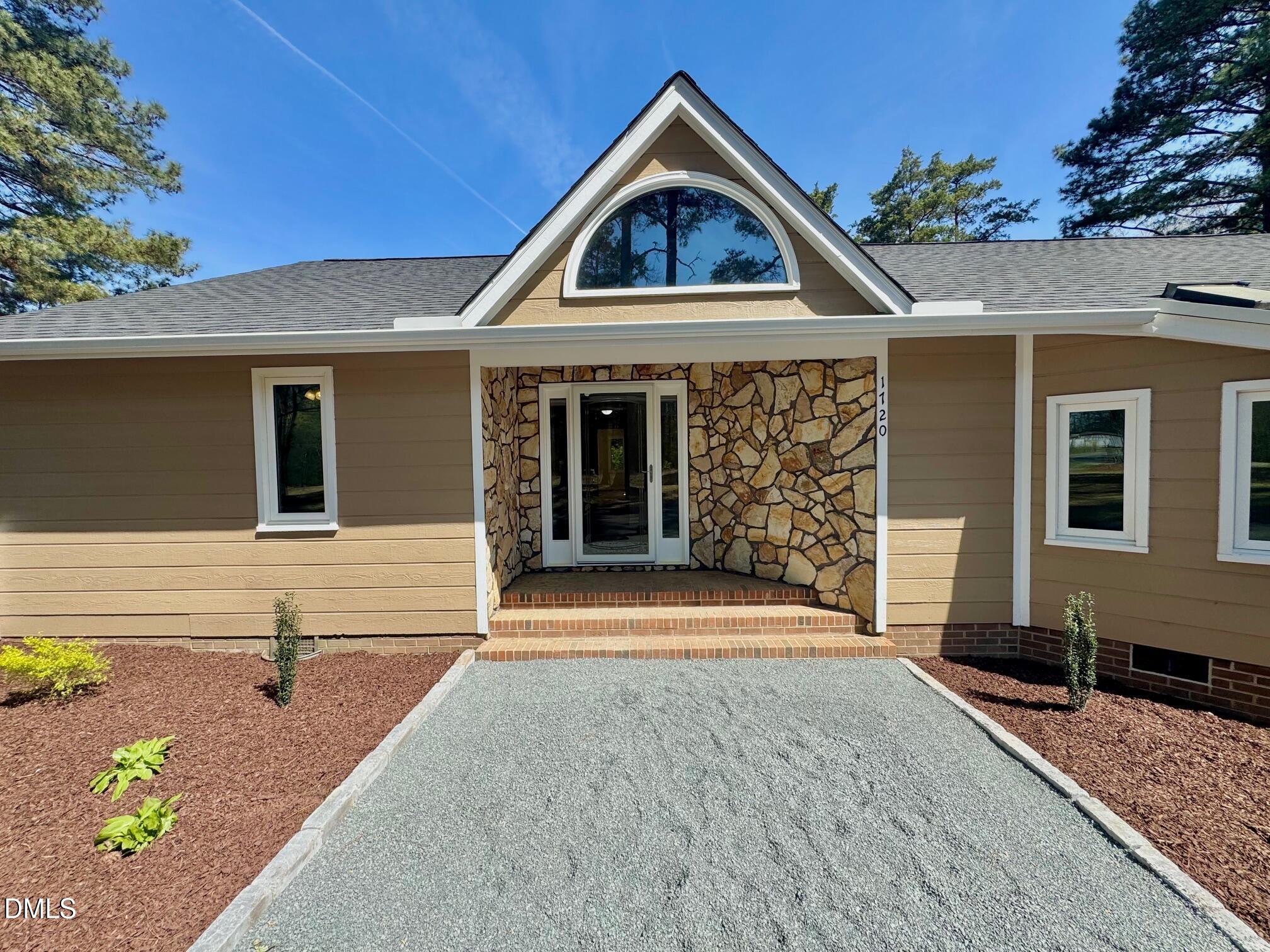 1720 Ross Mill Road Henderson, NC 27537 - Photo 6 of 42 a front view of a house with garden