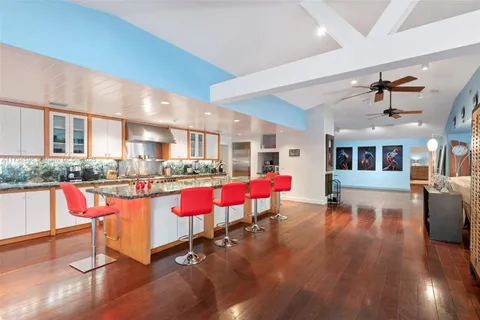 a living room with furniture and kitchen view