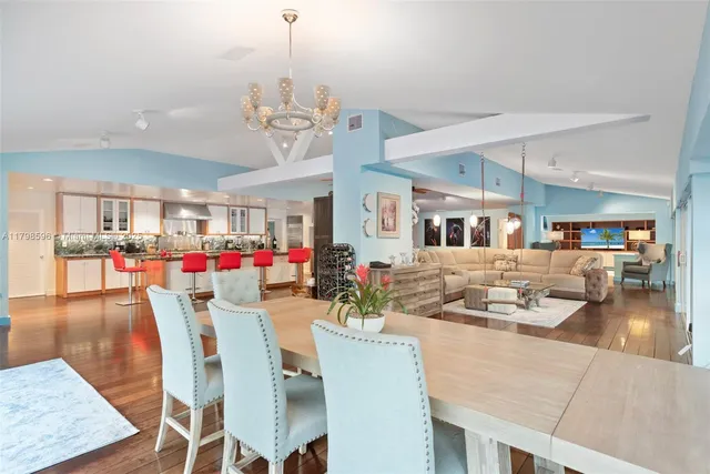 a view of a dining room and livingroom with lots of furniture and wooden floor