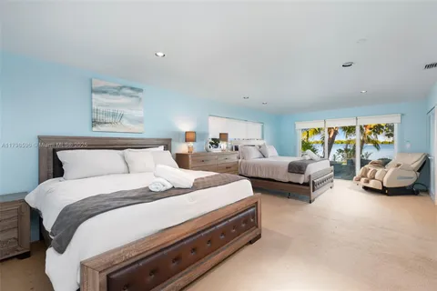 a bedroom with bed and a couch