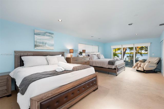 a bedroom with bed and a couch