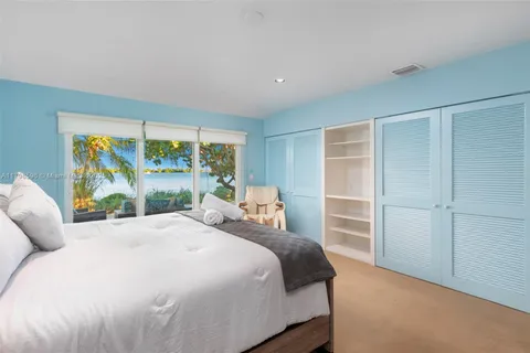 a bedroom with a large bed and a large window