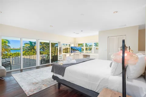 a bedroom with a large bed and a large window