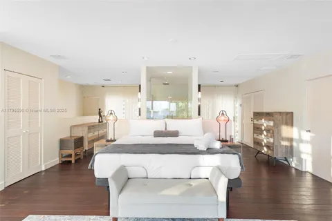 a living room with furniture a wooden floor and a large window