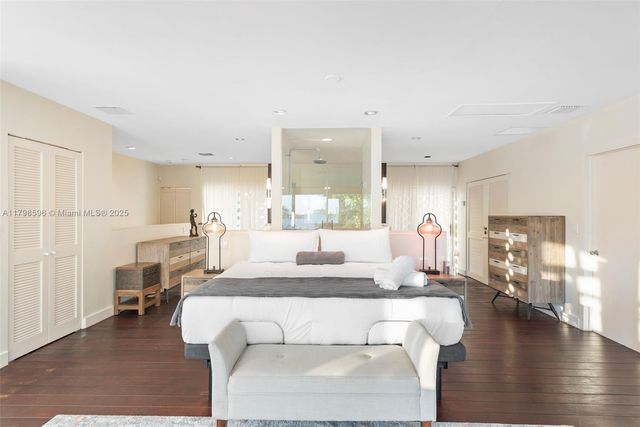 a living room with furniture a wooden floor and a large window