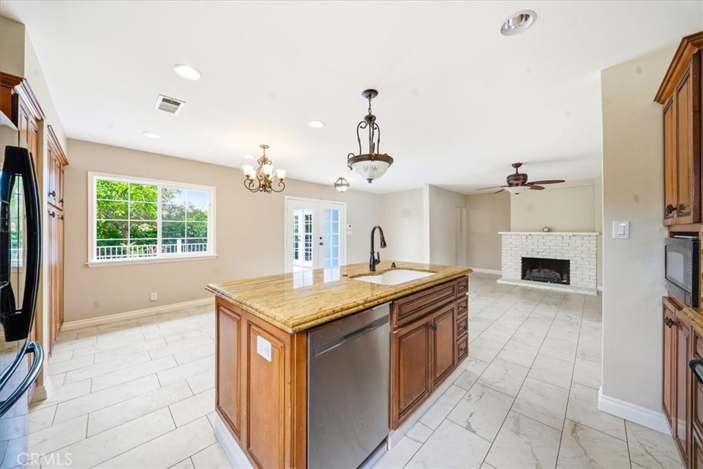 6481 Dos Rios Road Downey, CA 90240 - Photo 26 of 27 a kitchen with a stove sink and cabinets