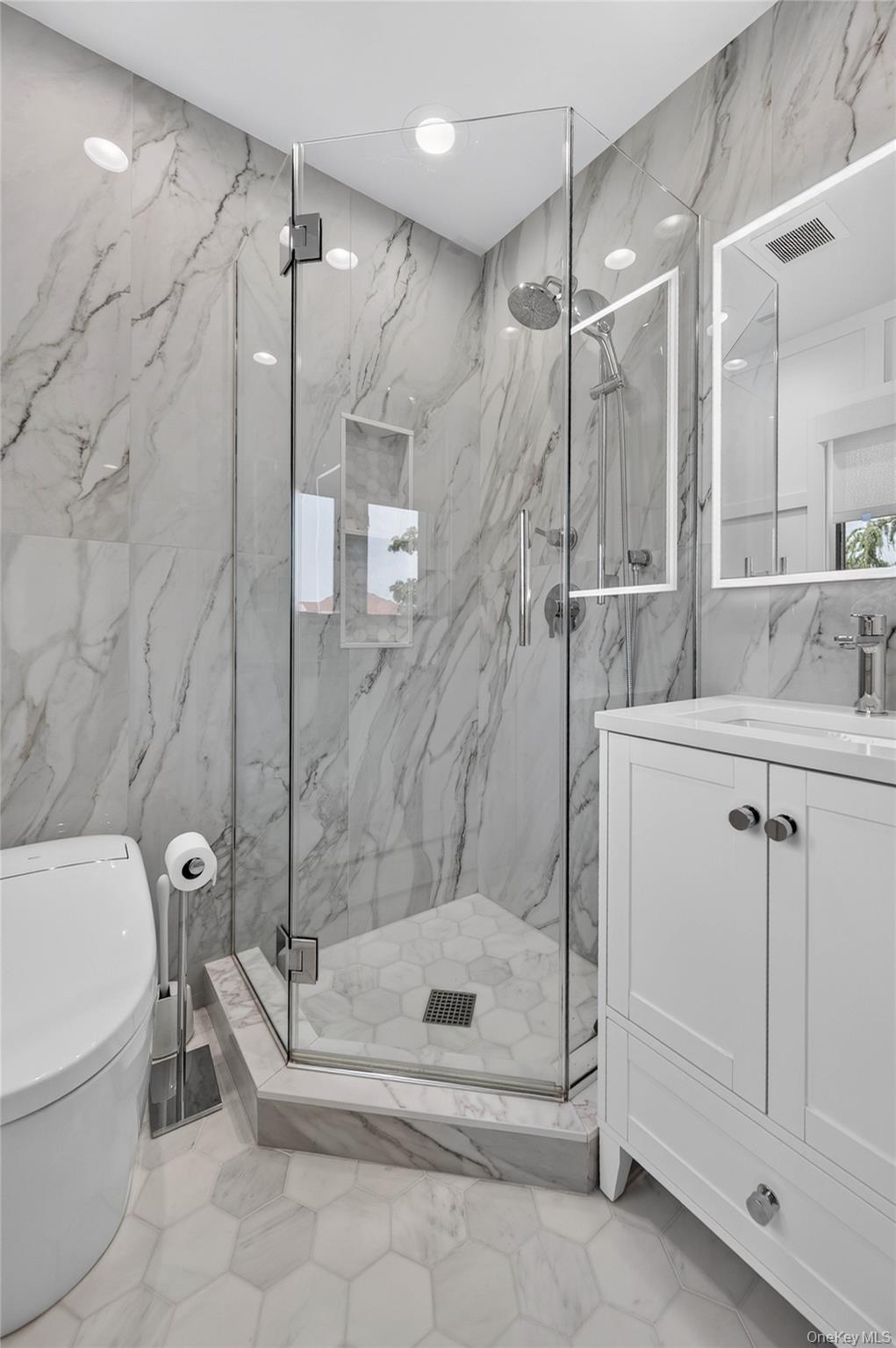 11 Sunbeam Road Syosset, NY 11791 - Photo 13 of 28 Renovated primary bathroom with glass-enclosed shower and built-in niche