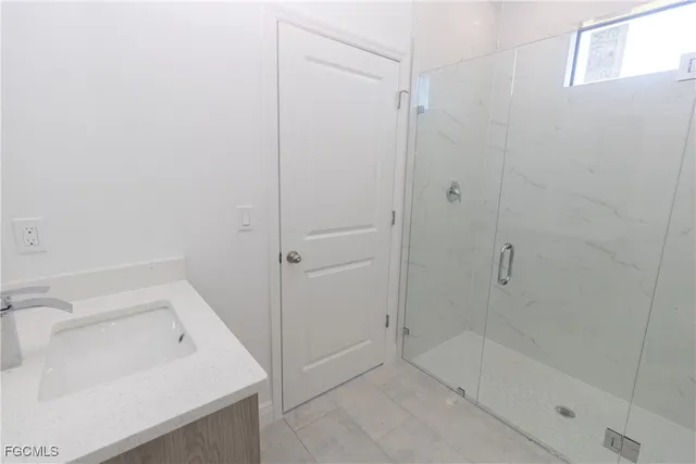 a bathroom with a sink and shower