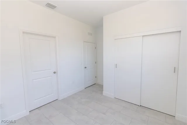 an empty room with closet area