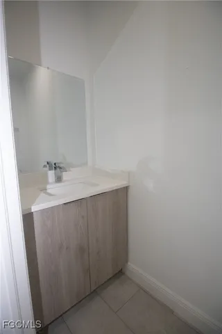 a room with a sink and a mirror