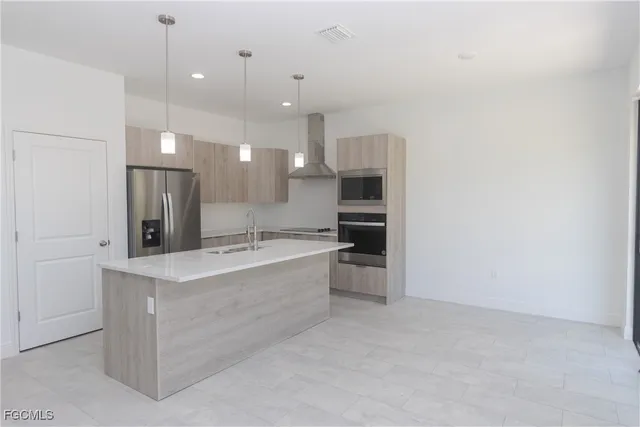 a large kitchen with kitchen island a sink stainless steel appliances and cabinets