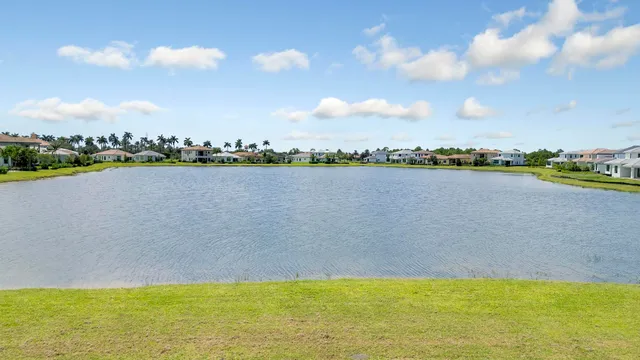 a view of a lake with houses in the background