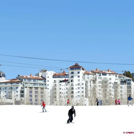 a view of a multi story residential apartment building with a yard