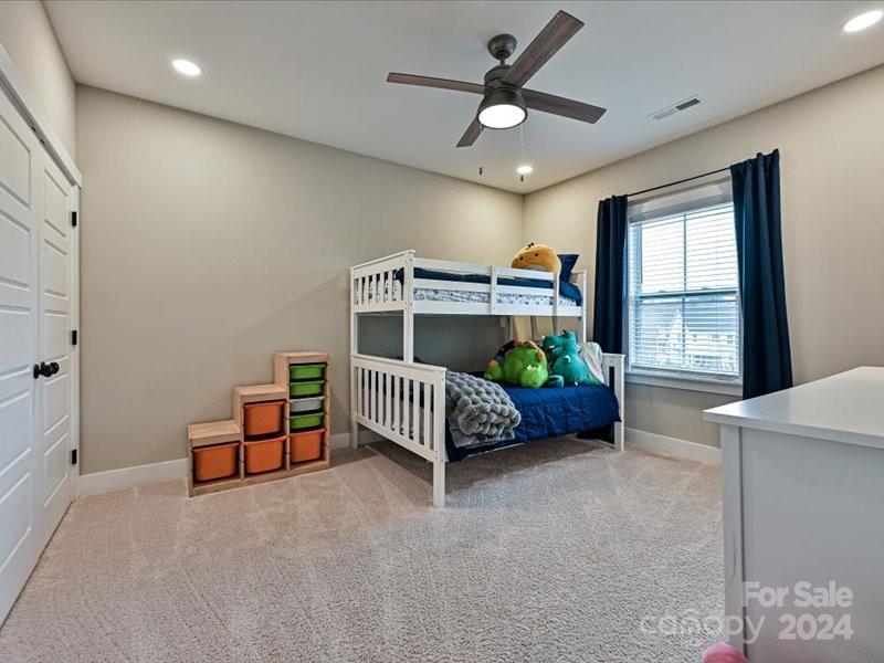 1426 Porch Wisdom Court Fort Mill, SC 29708 - Photo 29 of 48 a bed room with a bed and a chandelier