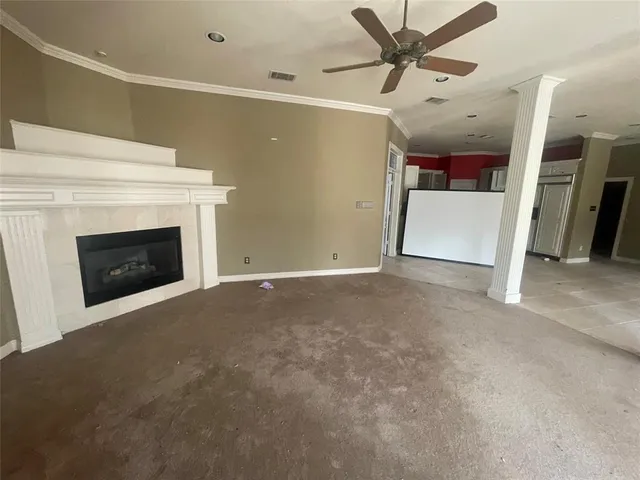 a view of a livingroom with an empty space and a fireplace