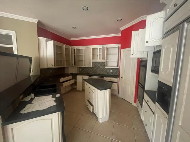 a kitchen with a sink stove and refrigerator