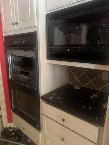 a kitchen with a stove and a microwave