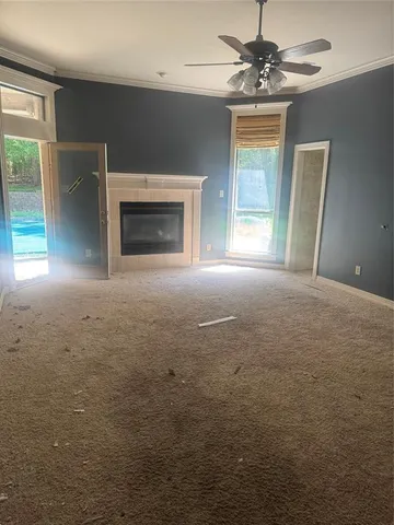 a view of empty room with fireplace and fan