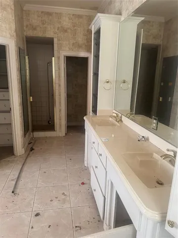 a spacious bathroom with a double vanity sink and a mirror