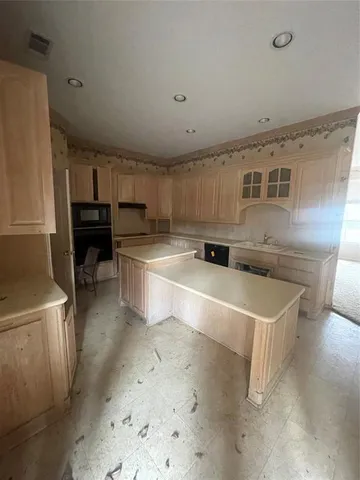 a kitchen with stainless steel appliances a stove a sink and a refrigerator
