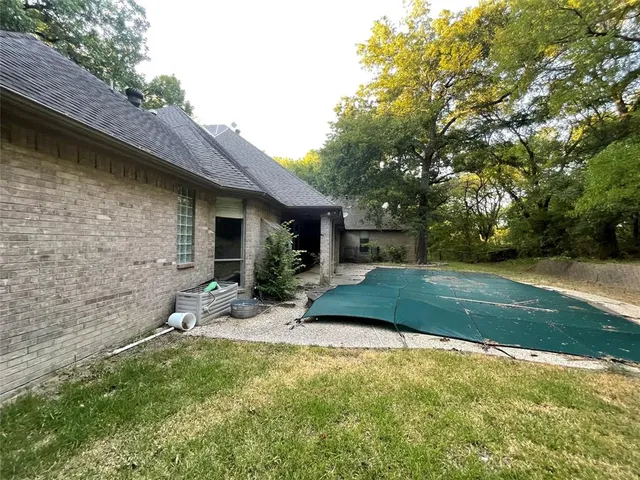 a view of backyard of house with outdoor seating and green space