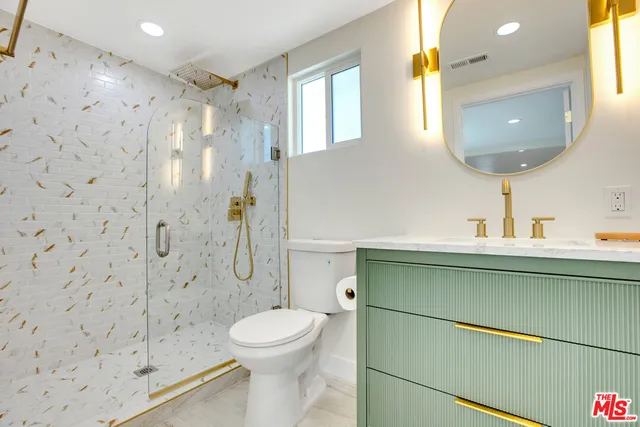 a bathroom with a toilet sink and shower