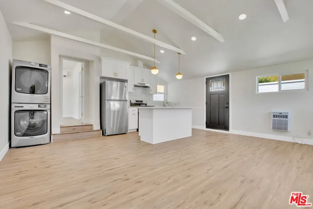 a view of a kitchen with a sink and a refrigerator