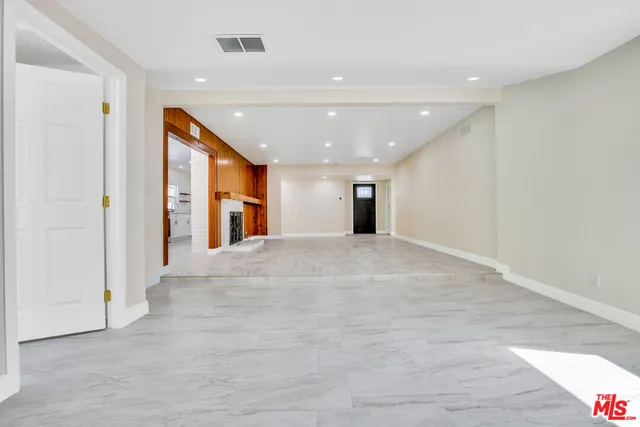 a view of a hallway with wooden shelves