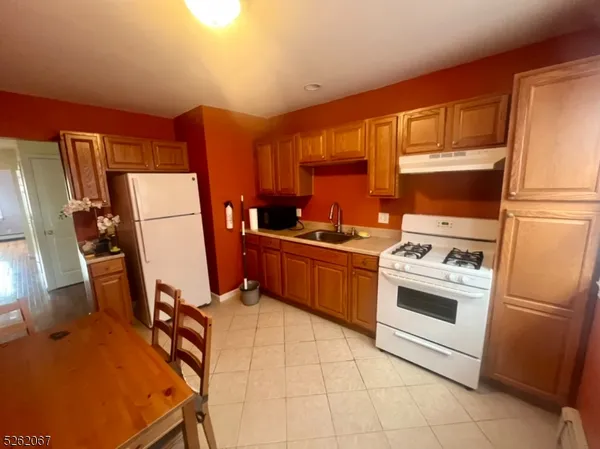 a kitchen with stainless steel appliances a stove a refrigerator and a sink