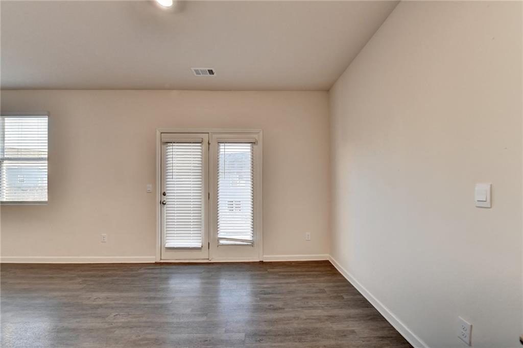 393 Walnut Grv Way Pendergrass, GA 30567 - Photo 15 of 45 a view of an empty room with wooden floor and a window